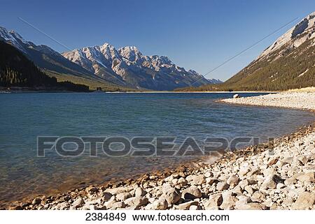 Stock Photo - Mountain lake and blue sky; Alberta, Canada. Fotosearch