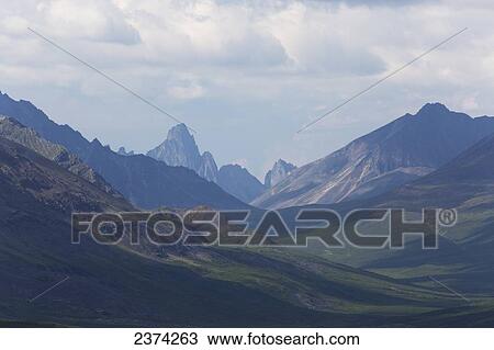 Mountain valley with clouds and sunlit hillsides; Yukon, Canada View Large Photo Image Stock Image - Mountain valley with clouds and sunlit hillsides; Yukon, Canada. Fotosearch