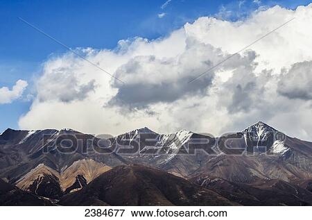 Stock Photo - Mountains and clouds; Qinghai province, Tibet, China. Fotosearch