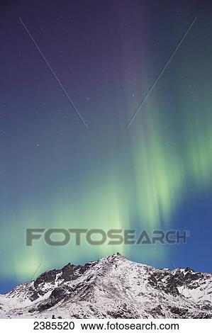Stock Image - Northern lights above the snow covered Talkeetna mountains, Hatchers Pass State Recreation Area; Alaska, United States of America. Fotosearch