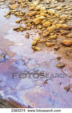Picture - Oil and road pollution from a highway leak into this river near Fort McMurray; Alberta, Canada. Fotosearch