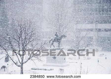 Stock Image - Plaza and monument in a snow storm; Calgary, Alberta, Canada. Fotosearch