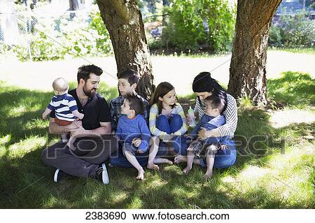 Stock Image - Portrait of a family in a park with five children; Victoria, British Columbia, Canada. Fotosearch