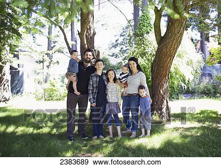 Stock Photo - Portrait of a family in a park with five children; Victoria, British Columbia, Canada. Fotosearch