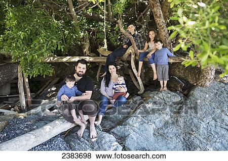 Portrait of a family sitting on large rocks; Victoria, British Columbia, Canada View Large Photo Image Stock Photo - Portrait of a family sitting on large rocks; Victoria, British Columbia, Canada. Fotosearch