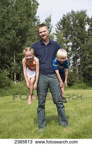 Portrait of a father with his young son and daughter; Stony Plain, Alberta, Canada View Large Photo Image Stock Image - Portrait of a father with his young son and daughter; Stony Plain, Alberta, Canada. Fotosearch