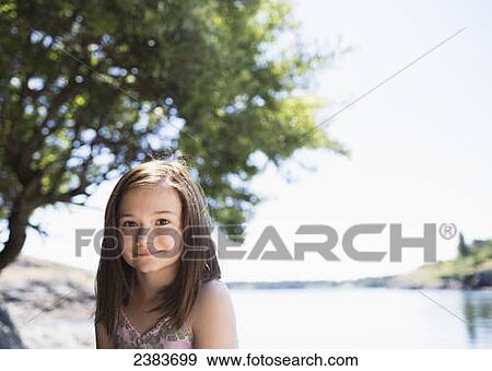 Stock Photo - Portrait of a girl with the ocean in the background; Victoria, British Columbia, Canada. Fotosearch