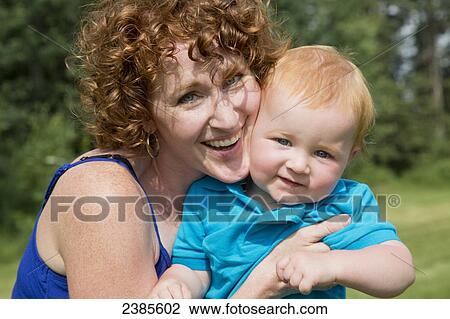 Stock Image - Portrait of a mother and her young son, both with red hair; Stony Plain, Alberta, Canada. Fotosearch