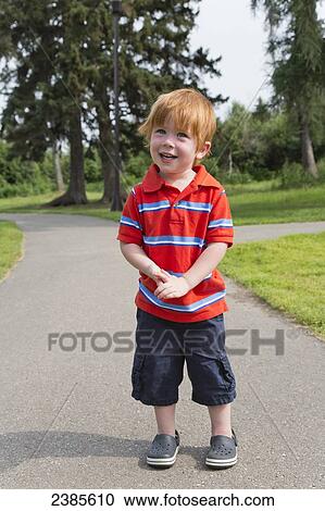 Portrait of a young boy with red hair standing on a path in a park; Stony Plain, Alberta, Canada View Large Photo Image Stock Image - Portrait of a young boy with red hair standing on a path in a park; Stony Plain, Alberta, Canada. Fotosearch