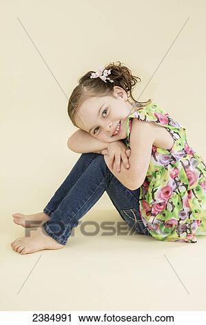 Portrait of a young girl wearing a floral shirt; Alberta, Canada View Large Photo Image Stock Image - Portrait of a young girl wearing a floral shirt; Alberta, Canada. Fotosearch