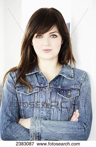 Stock Photo - Portrait of a young woman in a denim jacket; Montreal, Quebec, Canada. Fotosearch