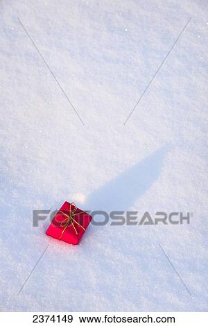 Red Christmas present in the snow; St. Albert, Alberta, Canada View Large Photo Image Stock Photo - Red Christmas present in the snow; St. Albert, Alberta, Canada. Fotosearch