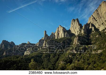 Stock Image - Rugged cliffs against a blue sky; Montserrat, Catalonia, Spain. Fotosearch