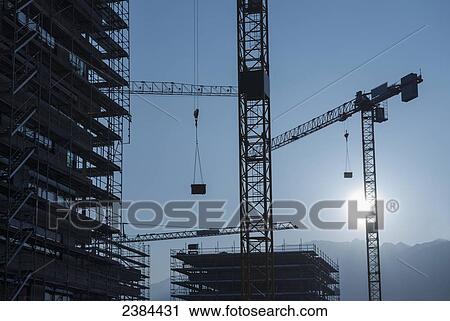 Silhouette of cranes and scaffolding for building construction; Locarno, Ticino, Switzerland View Large Photo Image Stock Image - Silhouette of cranes and scaffolding for building construction; Locarno, Ticino, Switzerland. Fotosearch