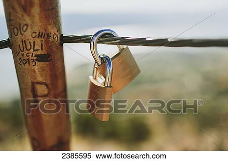 Small padlocks on a wire fence with names and dates etched into the post; Peachland, British Columbia, Canada View Large Photo Image Stock Photography - Small padlocks on a wire fence with names and dates etched into the post; Peachland, British Columbia, Canada. Fotosearch