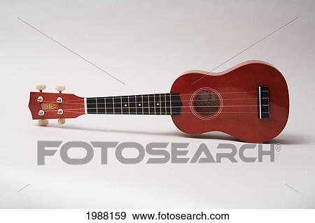 Stock Photo - Studio Shot Of An Ukulele Laying On A White Background.. Fotosearch