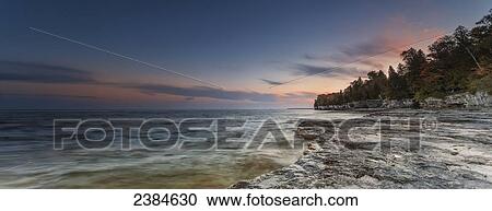 Stock Image - Sunrise at Cave Point in Sturgeon Bay; Wisconsin, United States of America. Fotosearch