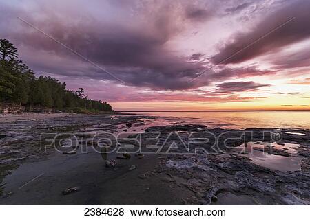 Sunrise at Cave Point; Wisconsin, United States of America View Large Photo Image Stock Photo - Sunrise at Cave Point; Wisconsin, United States of America. Fotosearch