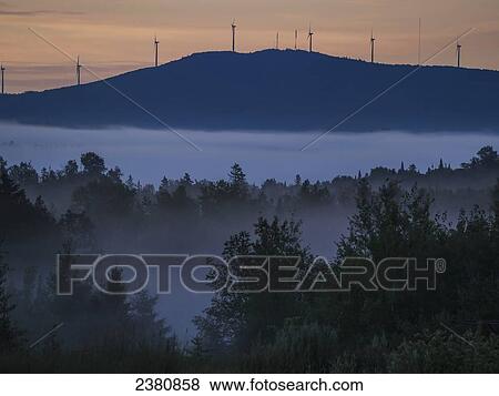 Stock Photo - Sunrise lights the sky over Mars Hill, a mountain near Presque Isle; Maine, United States of America. Fotosearch