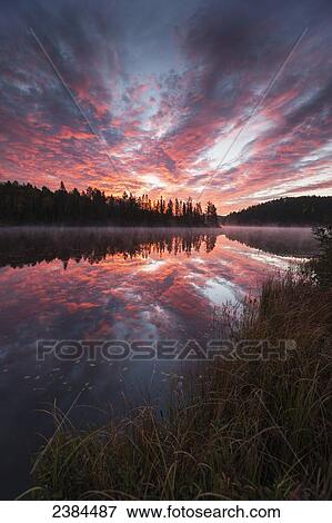 Stock Photo - Sunrise over Costello Lake, Algonquin Park; Ontario, Canada. Fotosearch