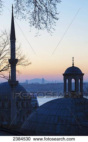 Stock Image - Sunset over Istanbul with an islamic mosque in the foreground; Istanbul, Turkey. Fotosearch