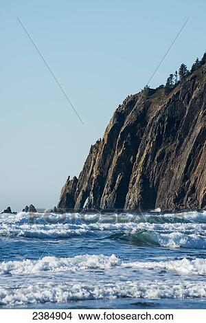 Picture - Surf breaks againt the bluffs at Oswald West State Park; Manzanita, Oregon, United States of America. Fotosearch