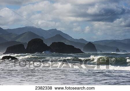 Surf breaks near sea stacks; Cannon Beach, Oregon, United States of America View Large Photo Image Stock Photo - Surf breaks near sea stacks; Cannon Beach, Oregon, United States of America. Fotosearch