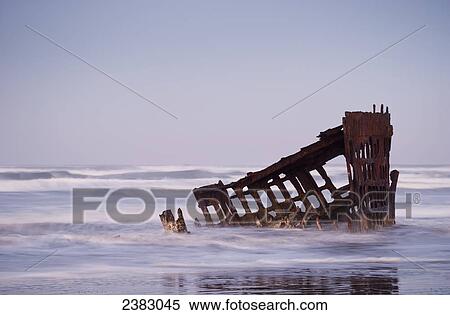 Surf washes over the skeleton of the Peter Iredale; Oregon, United States of America View Large Photo Image Stock Photography - Surf washes over the skeleton of the Peter Iredale; Oregon, United States of America. Fotosearch
