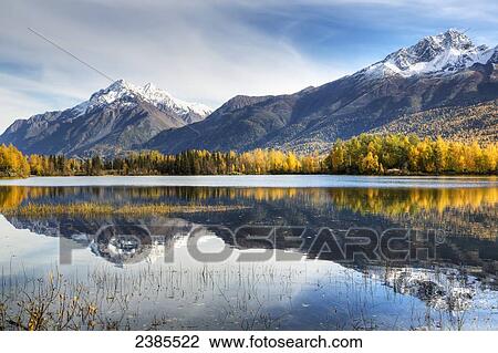 The snowcapped Chugach Mountains and autumn foliage reflecting in Reflections Lake along the Glenn Highway in the Matanuska Susitna Valley; Alaska, United States of America View Large Photo Image Stock Image - The snowcapped Chugach Mountains and autumn foliage reflecting in Reflections Lake along the Glenn Highway in the Matanuska Susitna Valley; Alaska, United States of America. Fotosearch