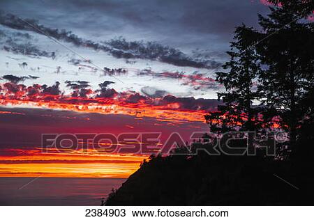 Stock Image - The sunset at Oswald West State Park; Manzanita, Oregon, United States of America. Fotosearch