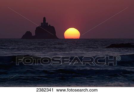 Stock Image - The sunset at Tillamook Rock Lighthouse; Cannon Beach, Oregon, United States of America. Fotosearch