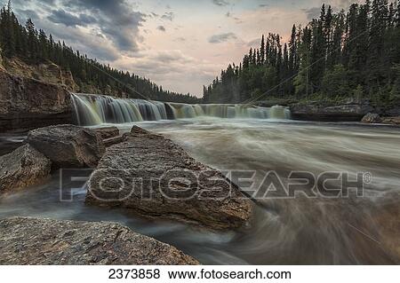 The Trout River flows over Sambaa Deh Falls in Sambaa Deh Territorial Park; Northwest Territories, Canada View Large Photo Image Stock Photo - The Trout River flows over Sambaa Deh Falls in Sambaa Deh Territorial Park; Northwest Territories, Canada. Fotosearch