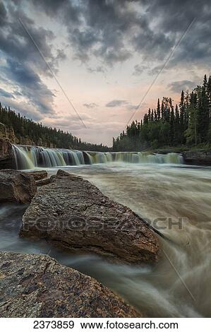 Stock Photo - The Trout River flows over Sambaa Deh Falls in Sambaa Deh Territorial Park; Northwest Territories, Canada. Fotosearch