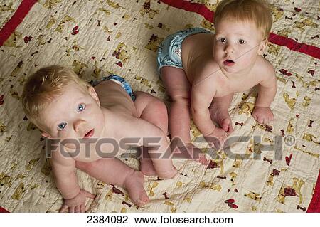 Stock Image - Twin baby boys; Alberta, Canada. Fotosearch