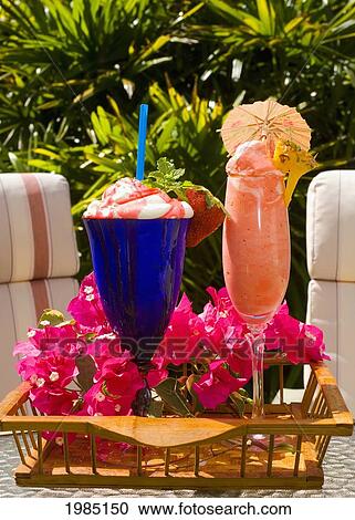 Stock Image - Two Creamy Tropical Drinks On A Tray Outdoors.. Fotosearch