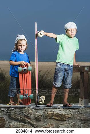 Two young boys with skateboards; Tarifa, Cadiz, Andalusia, Spain View Large Photo Image Picture - Two young boys with skateboards; Tarifa, Cadiz, Andalusia, Spain. Fotosearch
