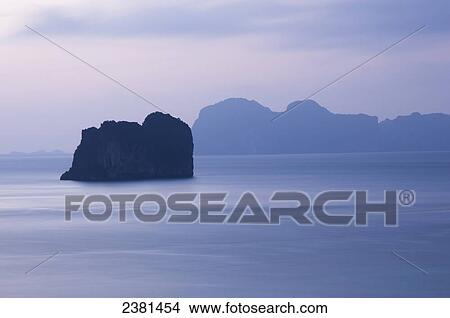 Uninhabited island off the coast of the island of Koh Ngai at dusk; Thailand View Large Photo Image Picture - Uninhabited island off the coast of the island of Koh Ngai at dusk; Thailand. Fotosearch
