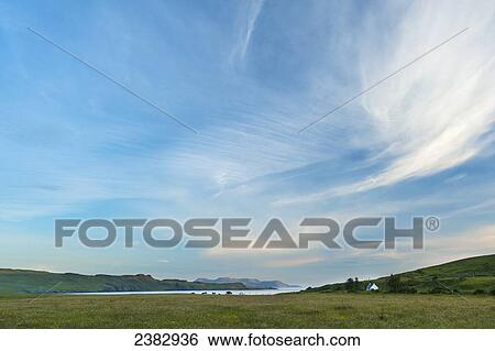 View across meadows of Glen Brittle out to the Isle of Rum catching the last of the evening sun; Isle of Skye, Scotland View Large Photo Image Stock Photograph - View across meadows of Glen Brittle out to the Isle of Rum catching the last of the evening sun; Isle of Skye, Scotland. Fotosearch