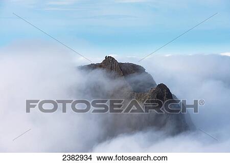 Picture - View from Sgurr Alasdair towards Sgurr Dearg and the Inaccessible Pinnacle emerging from cloud in the Black Cuillin; Isle of Skye, Scotland. Fotosearch