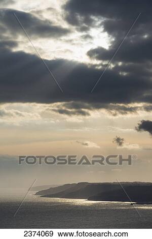 Stock Photo - View towards Lyme Regis from the top of Golden Cap on the Jurassic Coast; Seatown, Dorset, England. Fotosearch