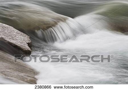 Water flowing over rocks in a waterfall; Whitehorse, Yukon, Canada View Large Photo Image Stock Photograph - Water flowing over rocks in a waterfall; Whitehorse, Yukon, Canada. Fotosearch