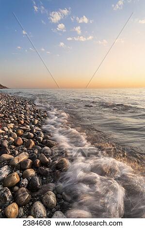 Waves hitting the rocks on the shoreline of Lake Michigan; Wisconsin, United States of America View Large Photo Image Stock Photo - Waves hitting the rocks on the shoreline of Lake Michigan; Wisconsin, United States of America. Fotosearch