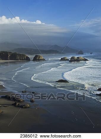 Stock Image - Waves wash onto Crescent Beach; Cannon Beach, Oregon, United States of America. Fotosearch
