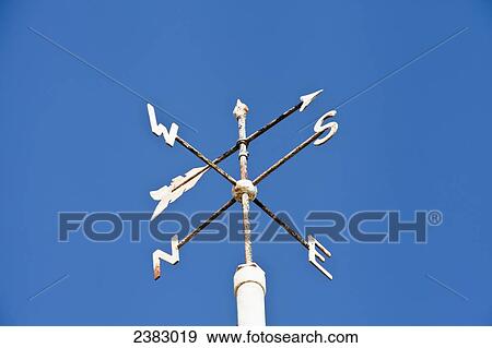 Stock Photo - Weather vane against a blue sky; England. Fotosearch