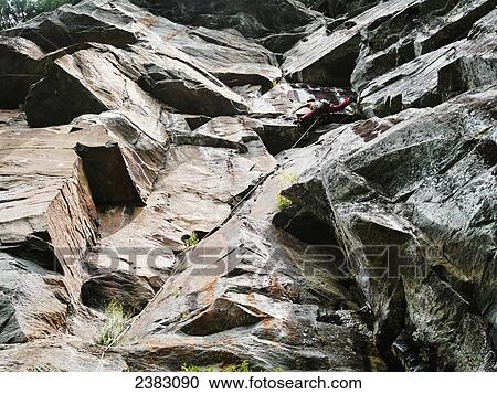 Woman climbing a rugged rock cliff; Quebec, Canada View Large Photo Image Stock Image - Woman climbing a rugged rock cliff; Quebec, Canada. Fotosearch