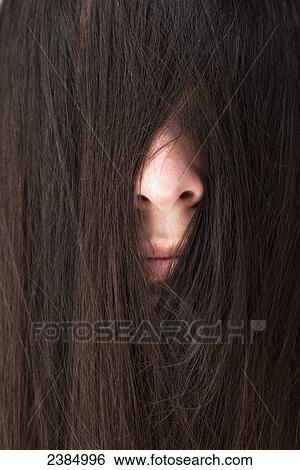 Woman with hair over her face; Stevenson, Maryland, United States of America View Large Photo Image Stock Photograph - Woman with hair over her face; Stevenson, Maryland, United States of America. Fotosearch