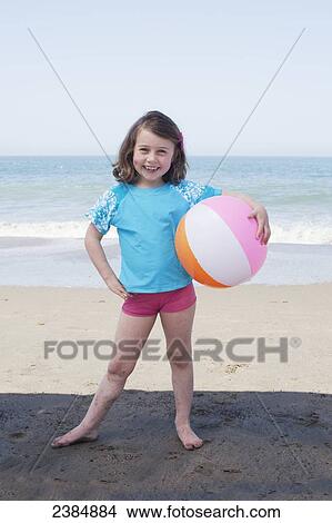 Young girl with a beach ball on the beach; San Francisco, California, United States of America View Large Photo Image Picture - Young girl with a beach ball on the beach; San Francisco, California, United States of America. Fotosearch