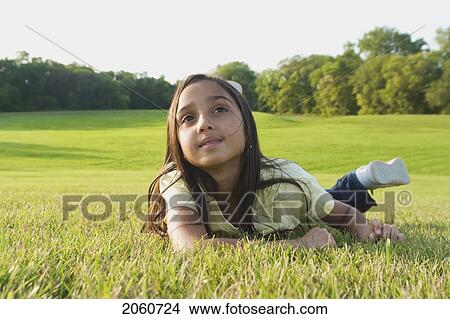 8 Year Old Girl Lying On Grass In Park, Winnipeg, Canada View Large Photo Image Picture - 8 Year Old Girl Lying On Grass In Park, Winnipeg, Canada. Fotosearch