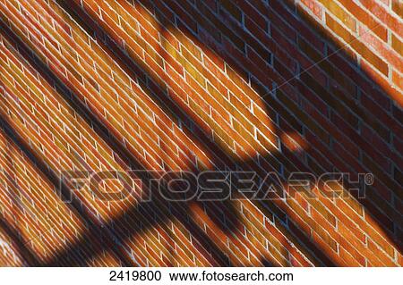 A brown brick wall with a shadow of a railing; Hamburg, Germany View Large Photo Image Stock Image - A brown brick wall with a shadow of a railing; Hamburg, Germany. Fotosearch