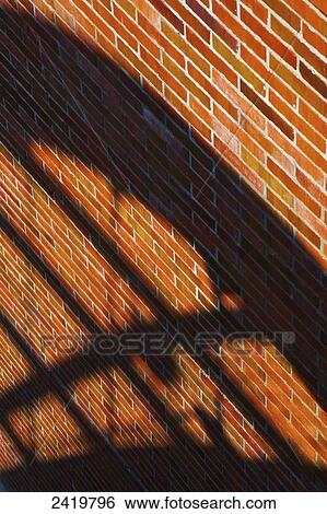 A brown brick wall with a shadow of a railing; Hamburg, Germany View Large Photo Image Stock Photograph - A brown brick wall with a shadow of a railing; Hamburg, Germany. Fotosearch